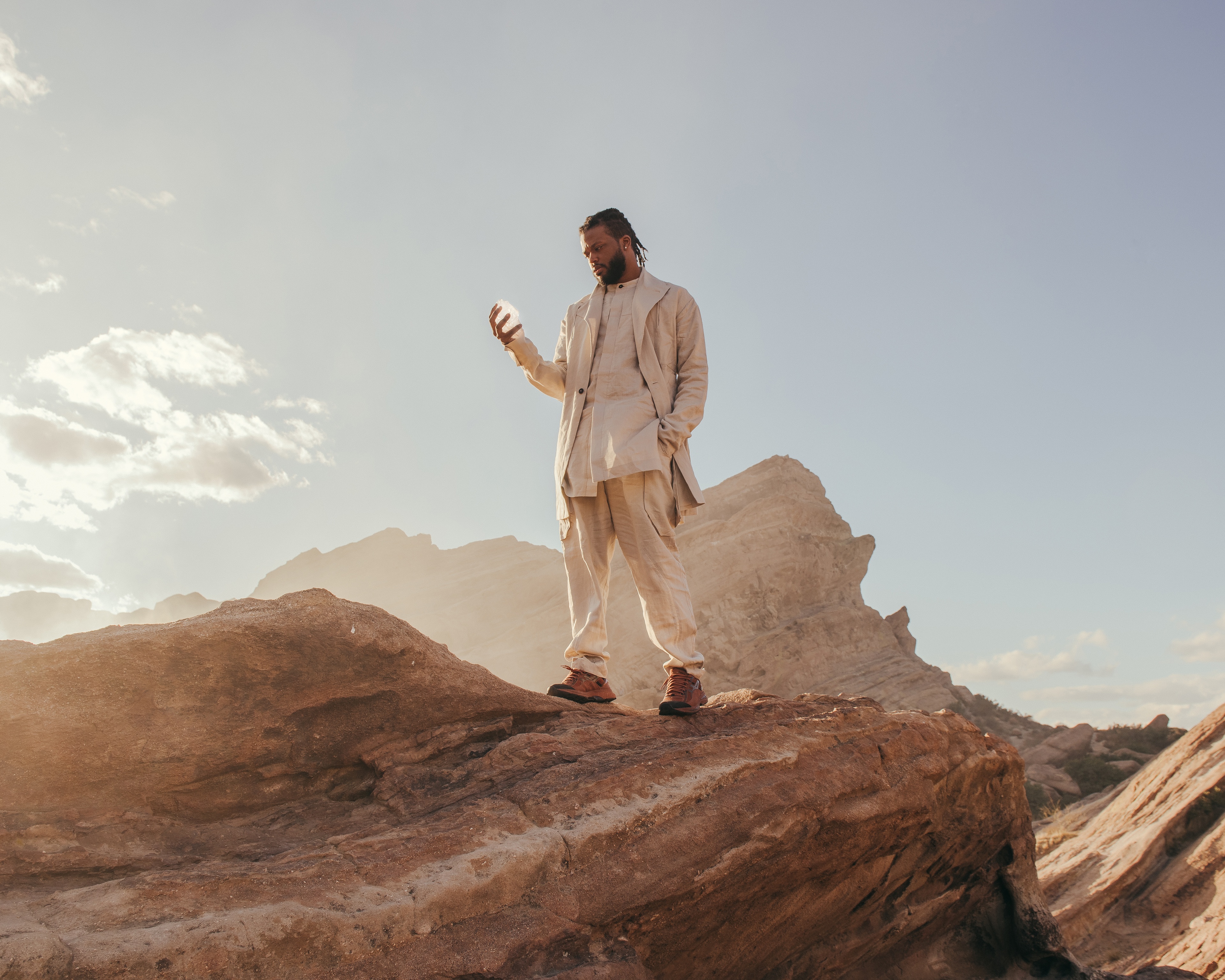 Our protagonist from A Handful of Dust stands in an arid desert landscape.